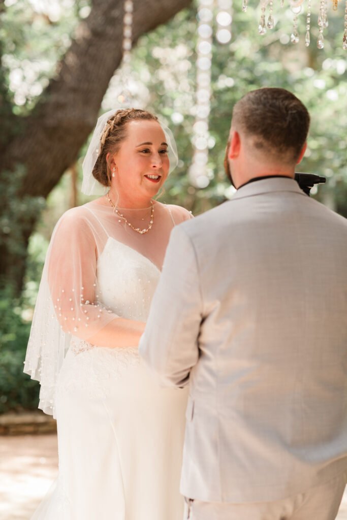Bride and groom exchange vows during outdoor wedding ceremony