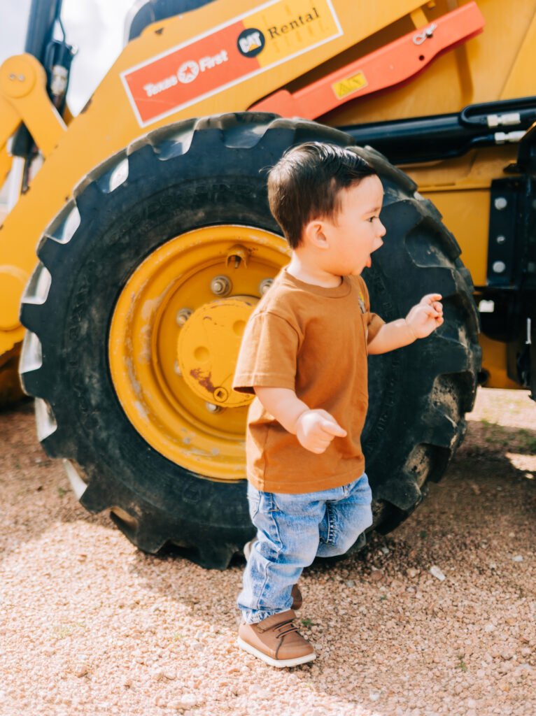 Toddler boy laughs during birthday photoshoot