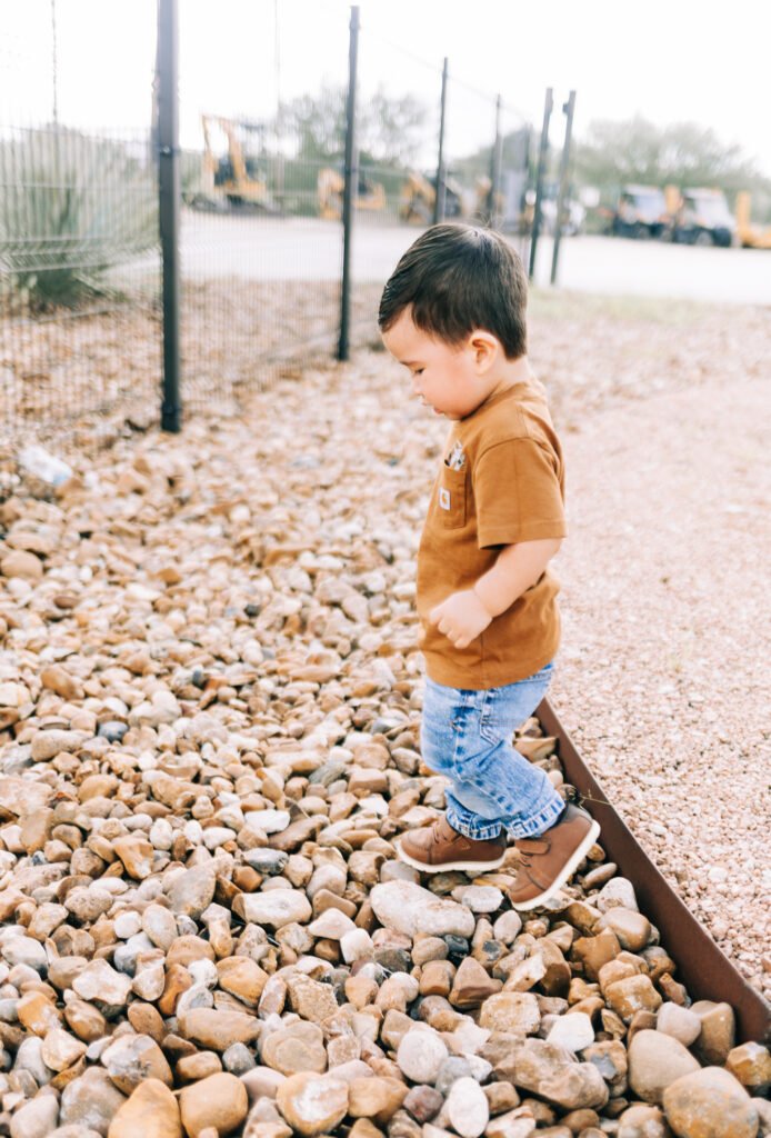 Boy walking on rocks during birthday photoshoot
