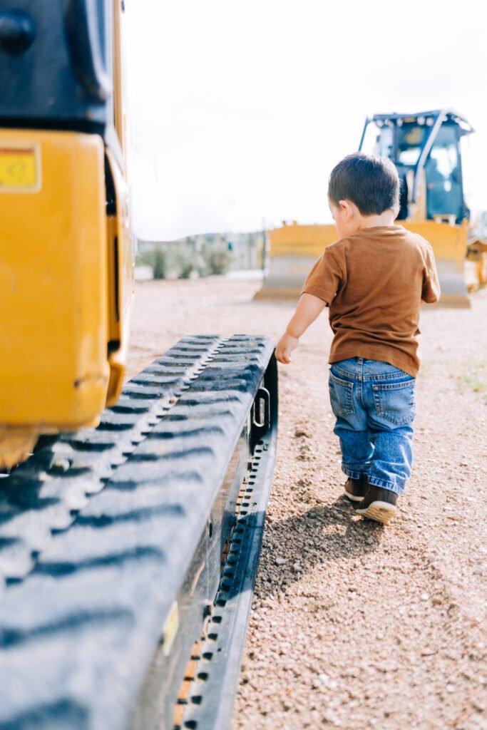 Young boy walking beside tractor for birthday photoshoot