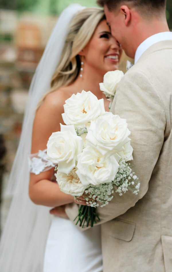 Bride holding her floral bouquet during wedding ceremony