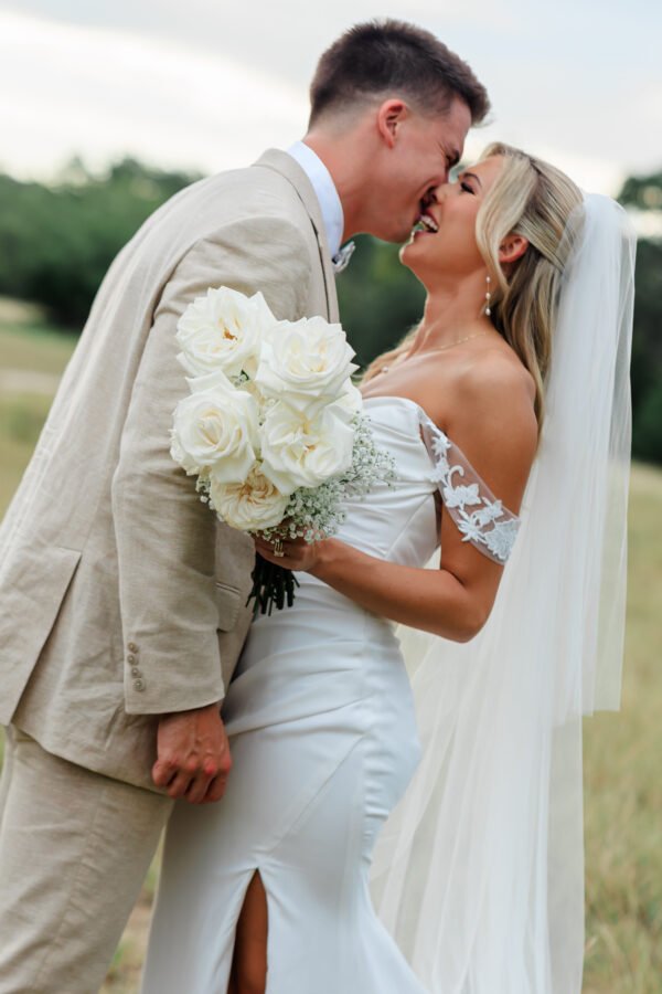 Bride and groom posing in front of Abilene Texas Wedding photographer