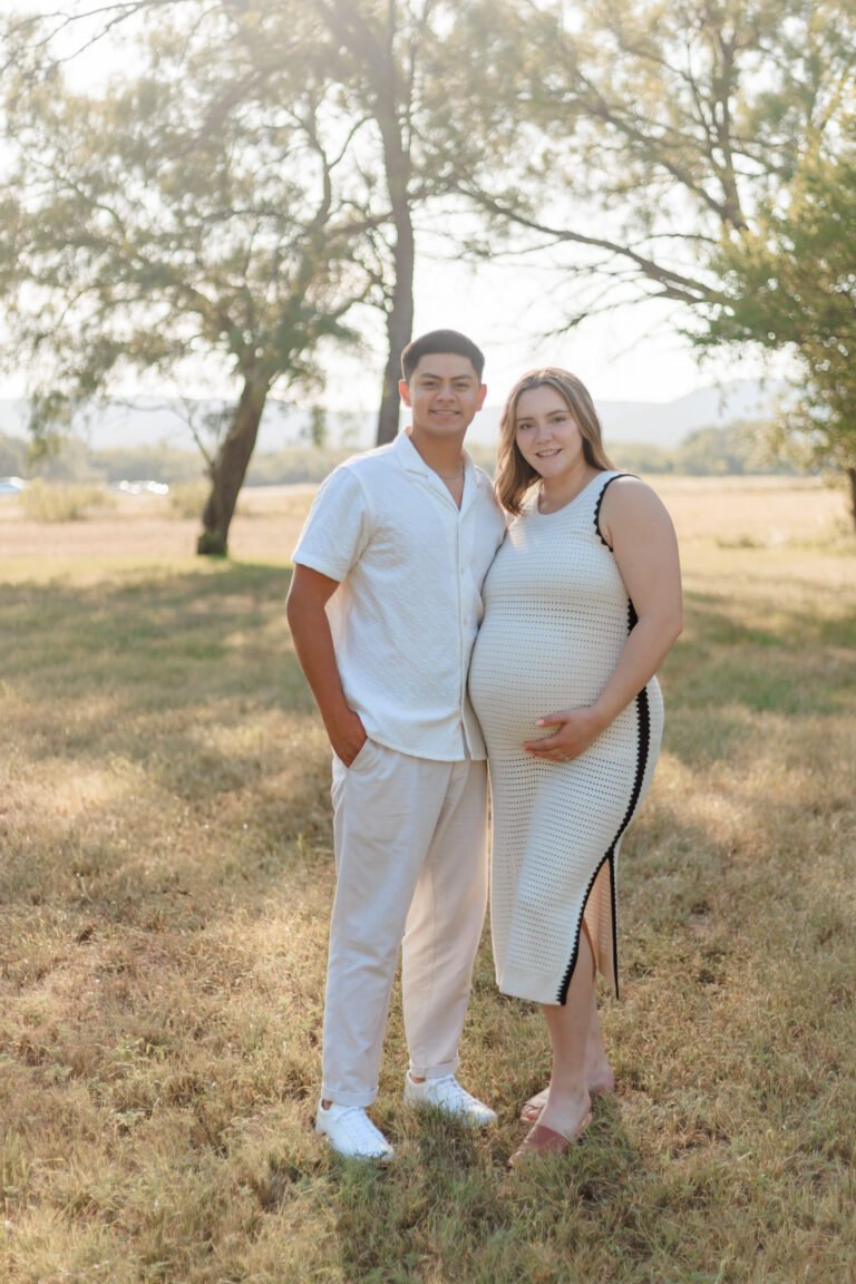 Couple walks holding hands in field of Buffalo Gap, Tx