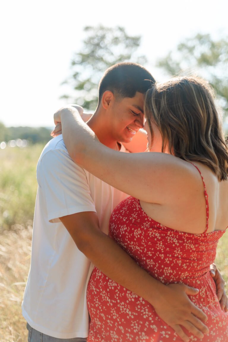 Couple hugs during maternity session in Buffalo Gap