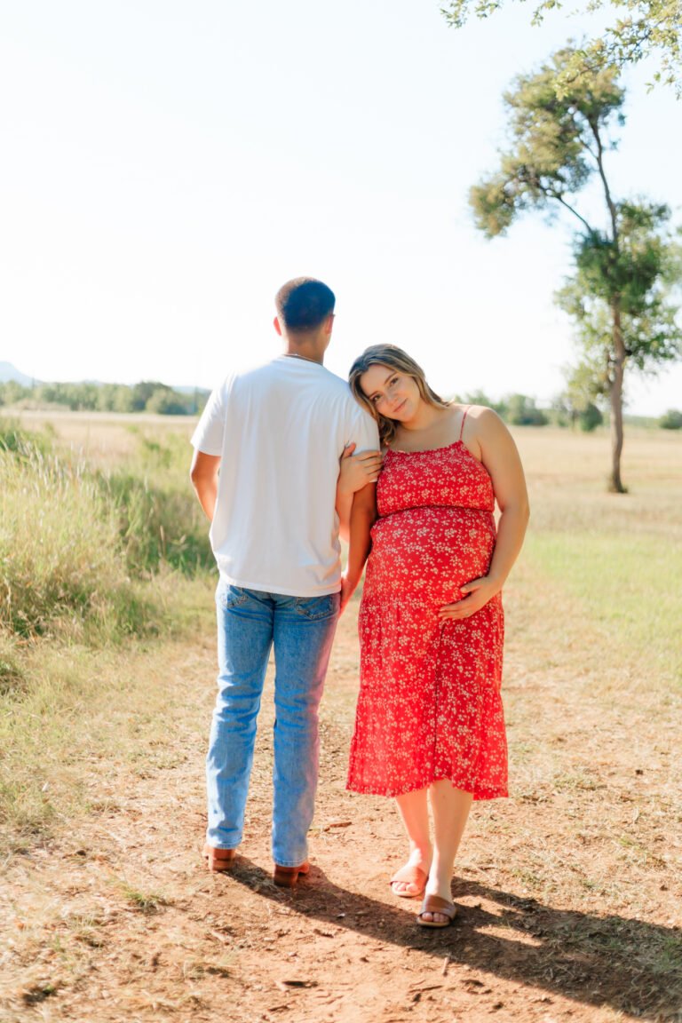 Couple walks holding hands in field of Buffalo Gap, Tx