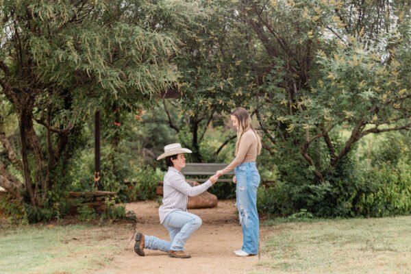 Couple proposing in front of Abilene Texas wedding photographer