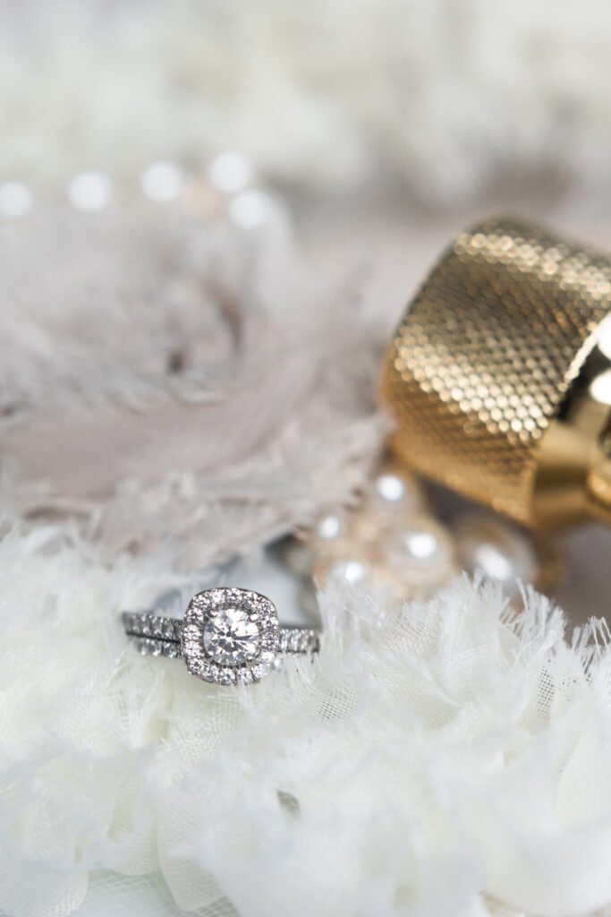 wedding ring and perfume in wedding detail shot