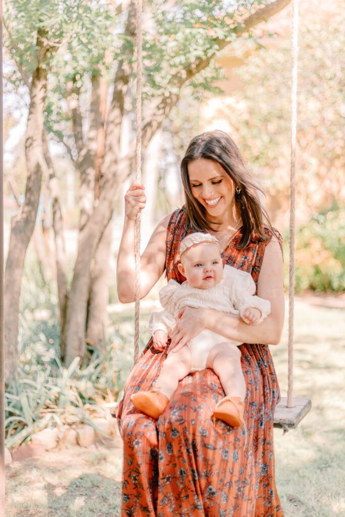 Mother and baby swinging together during photo session
