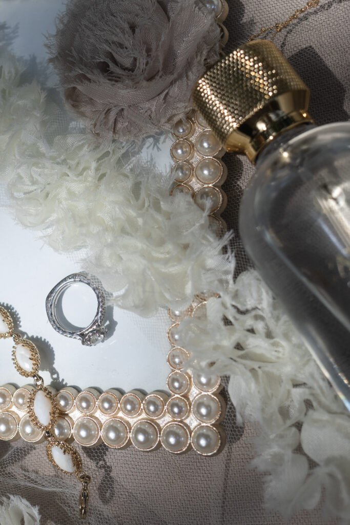 wedding details including perfume, bracelet and a ring